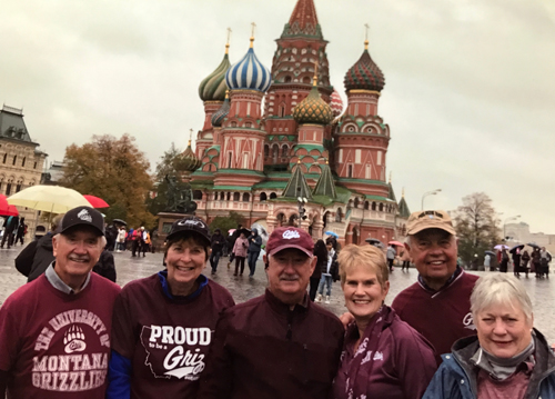 group of UM alumni in Griz gear stand in front of Russian landmark